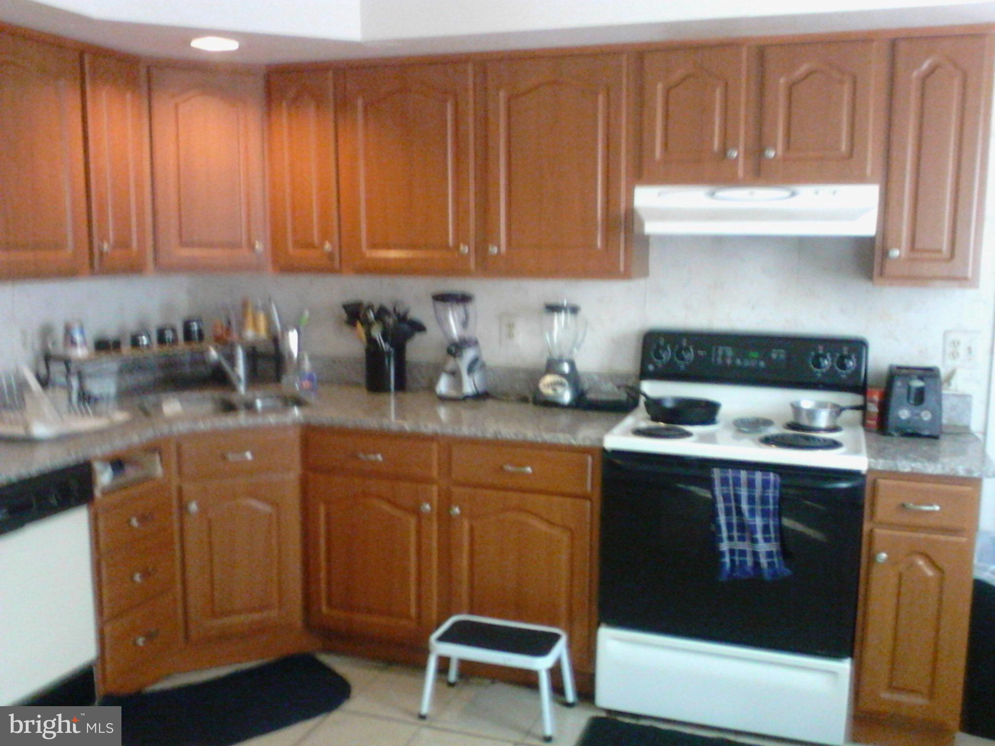 7600 Fox Hunt Court Clinton, MD 20735 - Photo 8 of 13 a kitchen with stainless steel appliances granite countertop a stove a sink dishwasher and cabinets with wooden floor