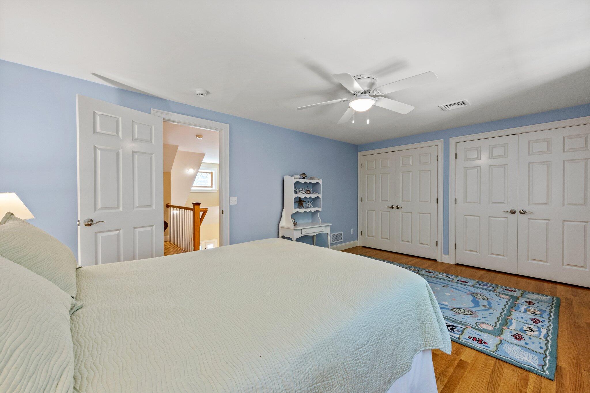 35 Angus Way Centerville, MA 02632 - Photo 28 of 62 a spacious bedroom with a bed and a chandelier