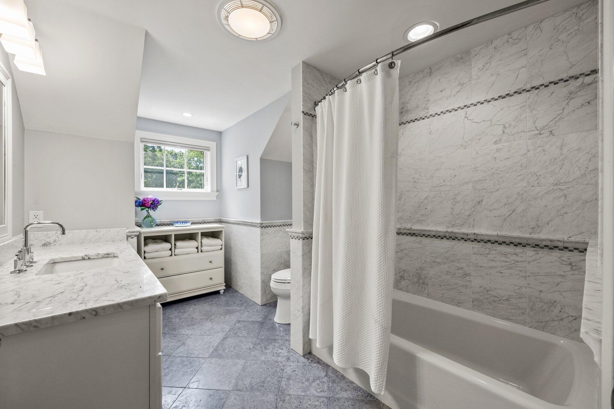 35 Angus Way Centerville, MA 02632 - Photo 30 of 62 a bathroom with a tub sink toilet and window
