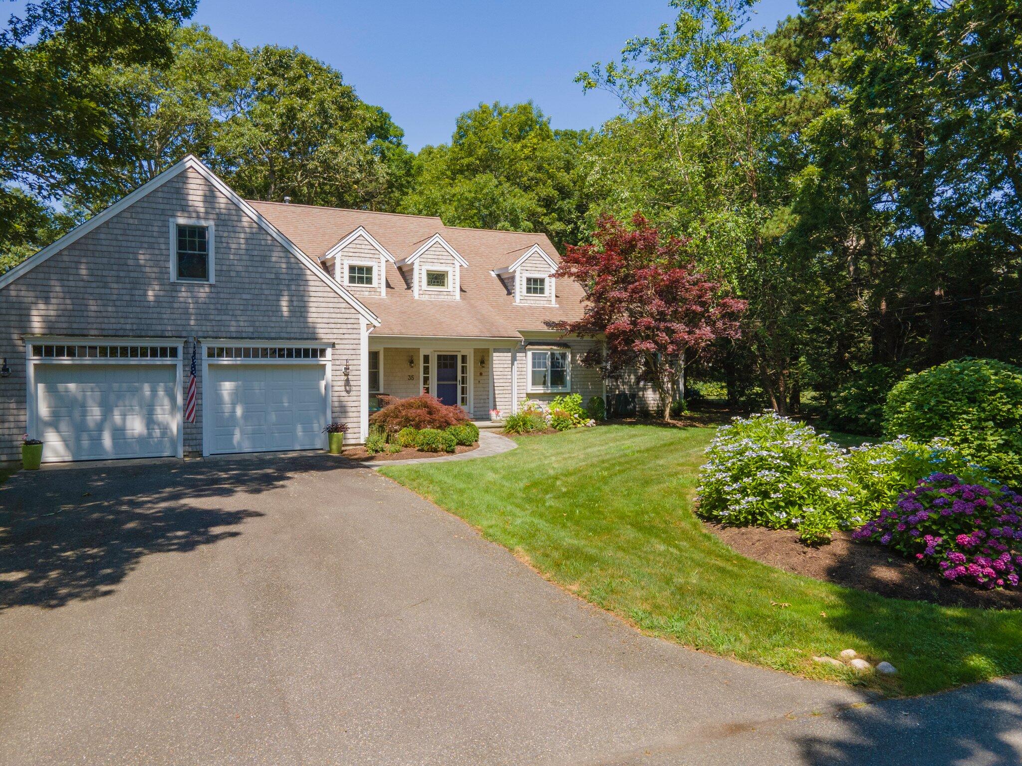 35 Angus Way Centerville, MA 02632 - Photo 55 of 62 a front view of a house with a garden and yard