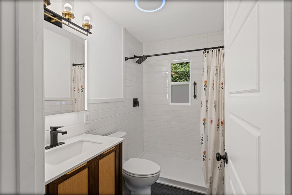 334 Shaler Street Pittsburgh, PA 15211 - Photo 11 of 31 a bathroom with a sink a toilet and shower