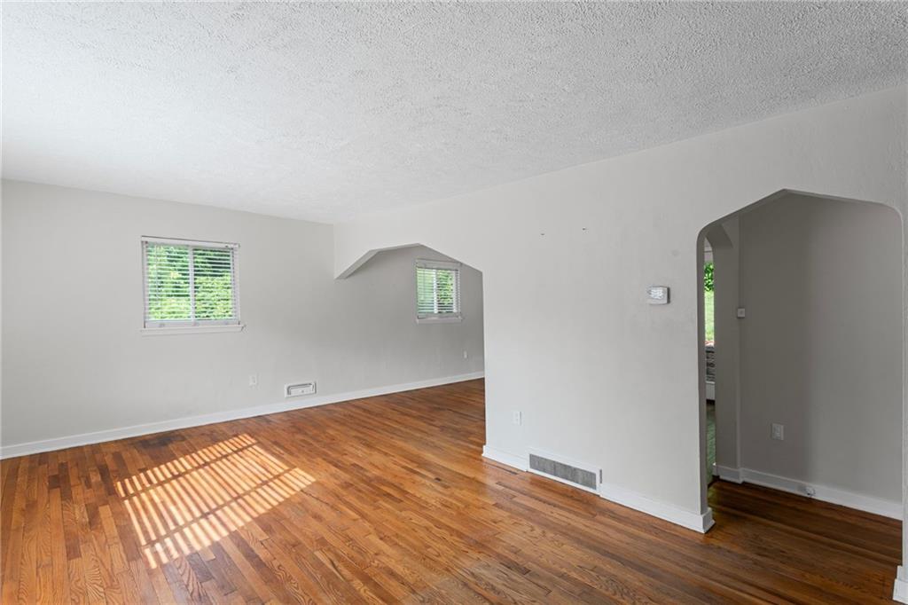 334 Shaler Street Pittsburgh, PA 15211 - Photo 3 of 31 an empty room with wooden floor and windows