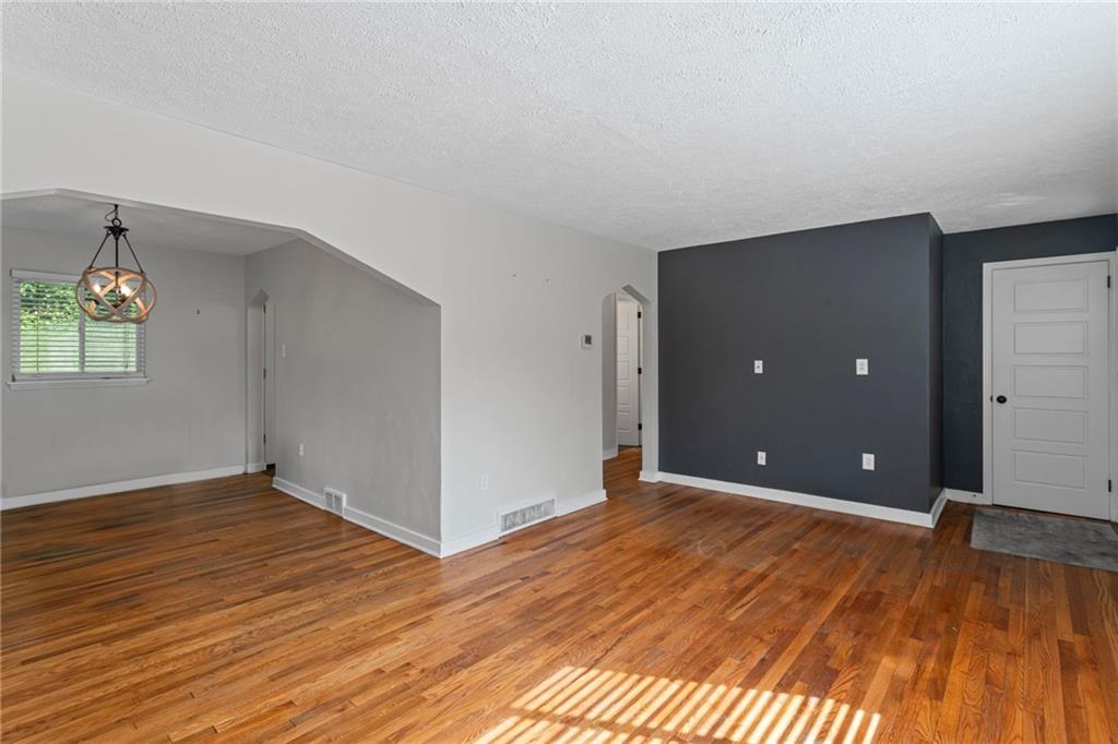 334 Shaler Street Pittsburgh, PA 15211 - Photo 4 of 31 wooden floor in an empty room with a window
