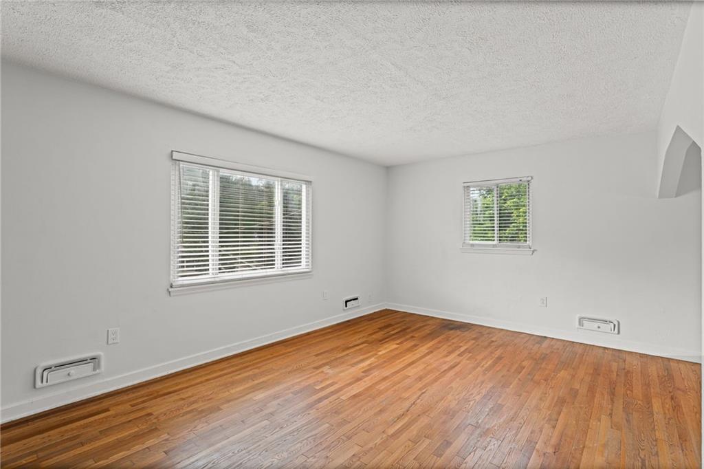 334 Shaler Street Pittsburgh, PA 15211 - Photo 6 of 31 an empty room with wooden floor and windows