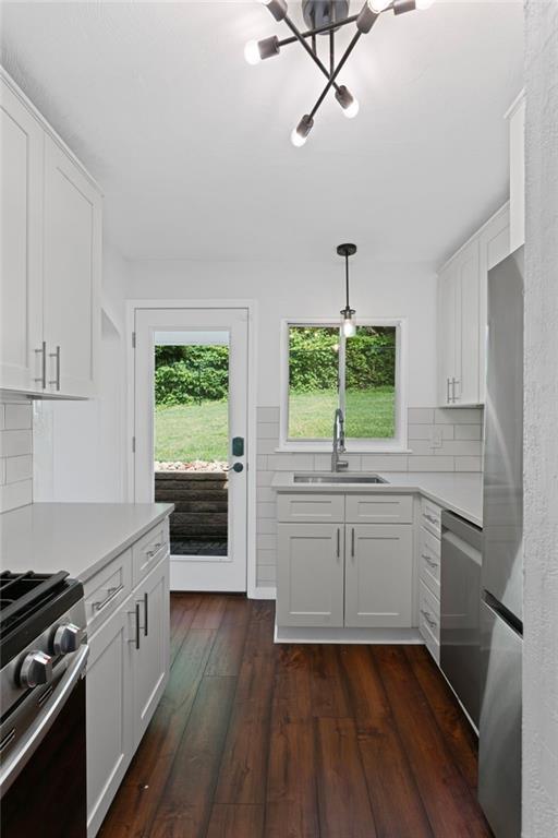334 Shaler Street Pittsburgh, PA 15211 - Photo 7 of 31 a kitchen with kitchen island white cabinets a sink a window and wooden floor