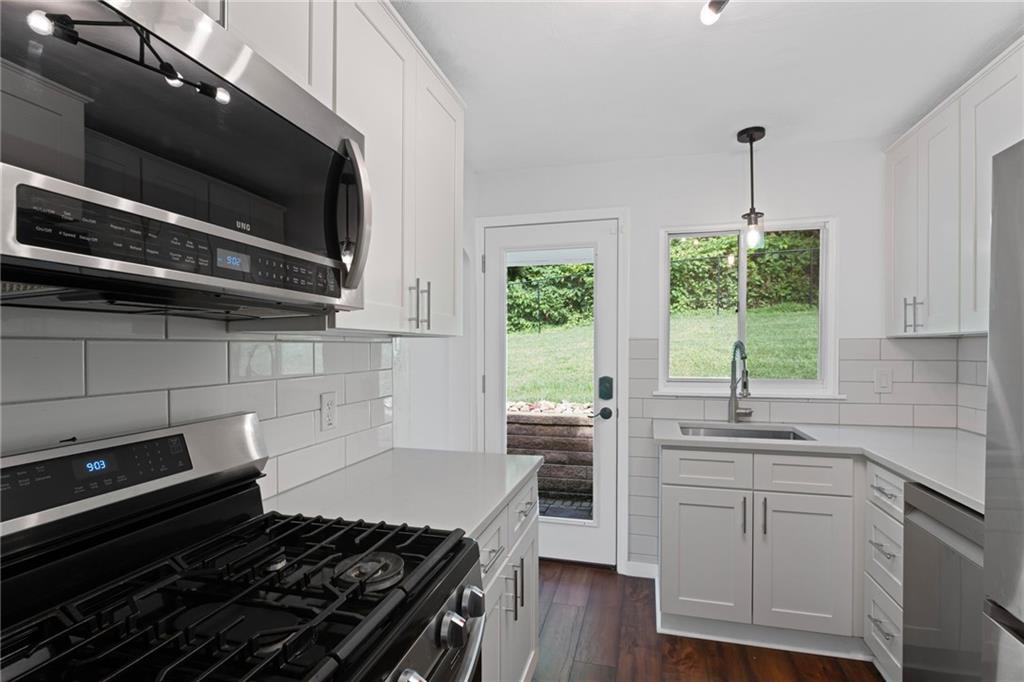 334 Shaler Street Pittsburgh, PA 15211 - Photo 10 of 31 a kitchen with a stove a sink and a microwave