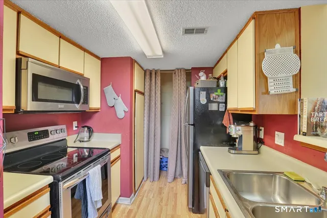 a kitchen that has a sink and a stove in it