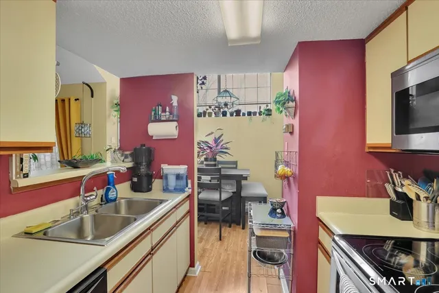 a kitchen with a sink stove and microwave