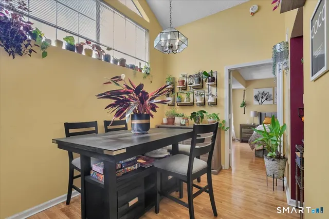 a view of a dining room with furniture and chandelier