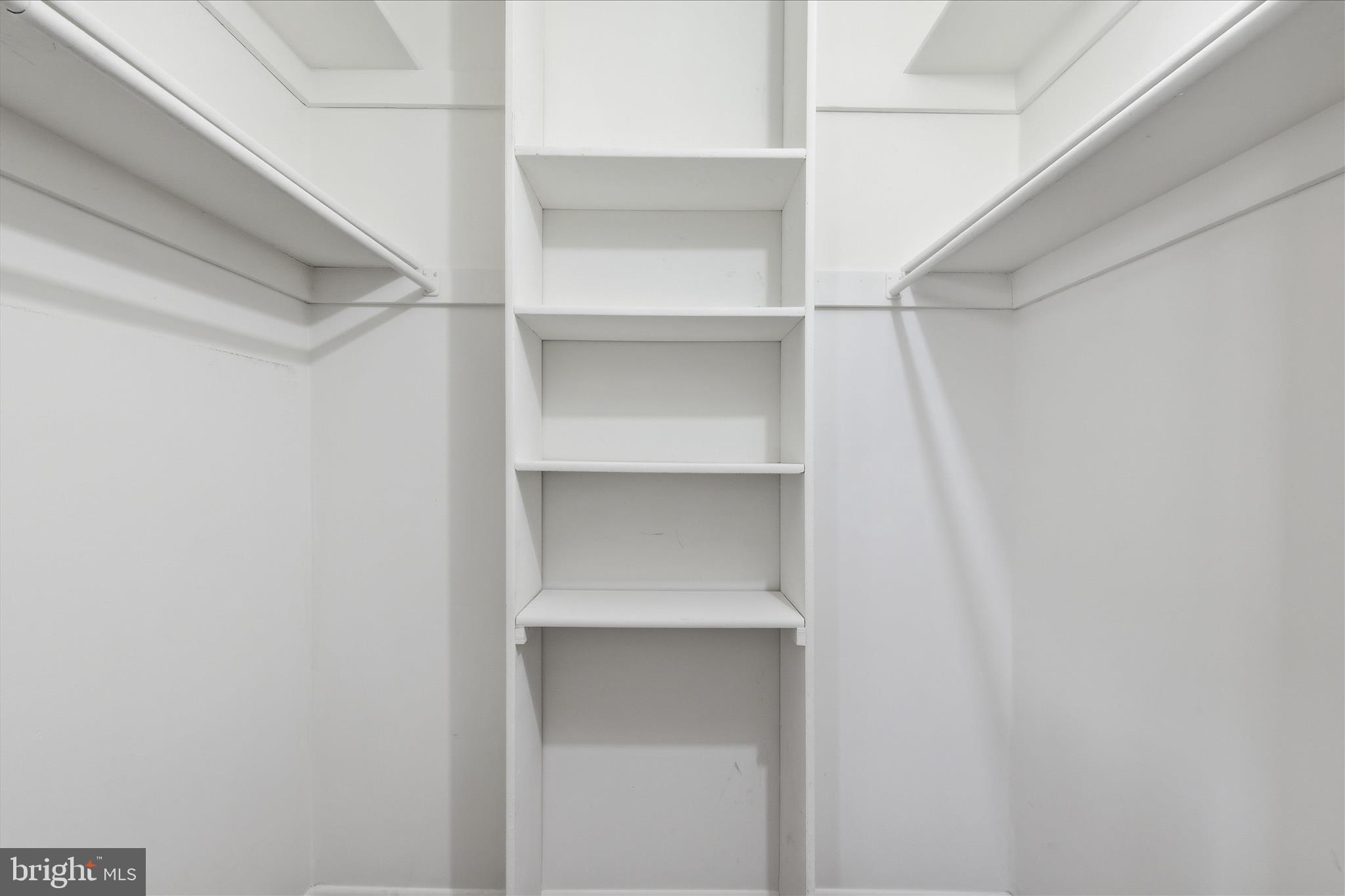 2255 Castle Rock Square, Unit 21C Reston, VA 20191 - Photo 11 of 33 a close up view of walk in closet with empty racks