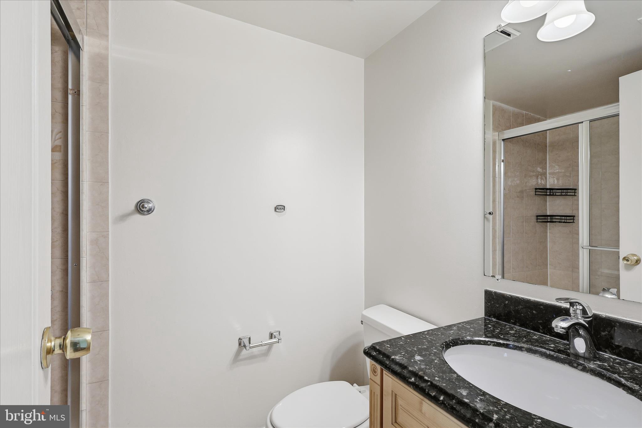 2255 Castle Rock Square, Unit 21C Reston, VA 20191 - Photo 12 of 33 a bathroom with a granite countertop sink and a mirror