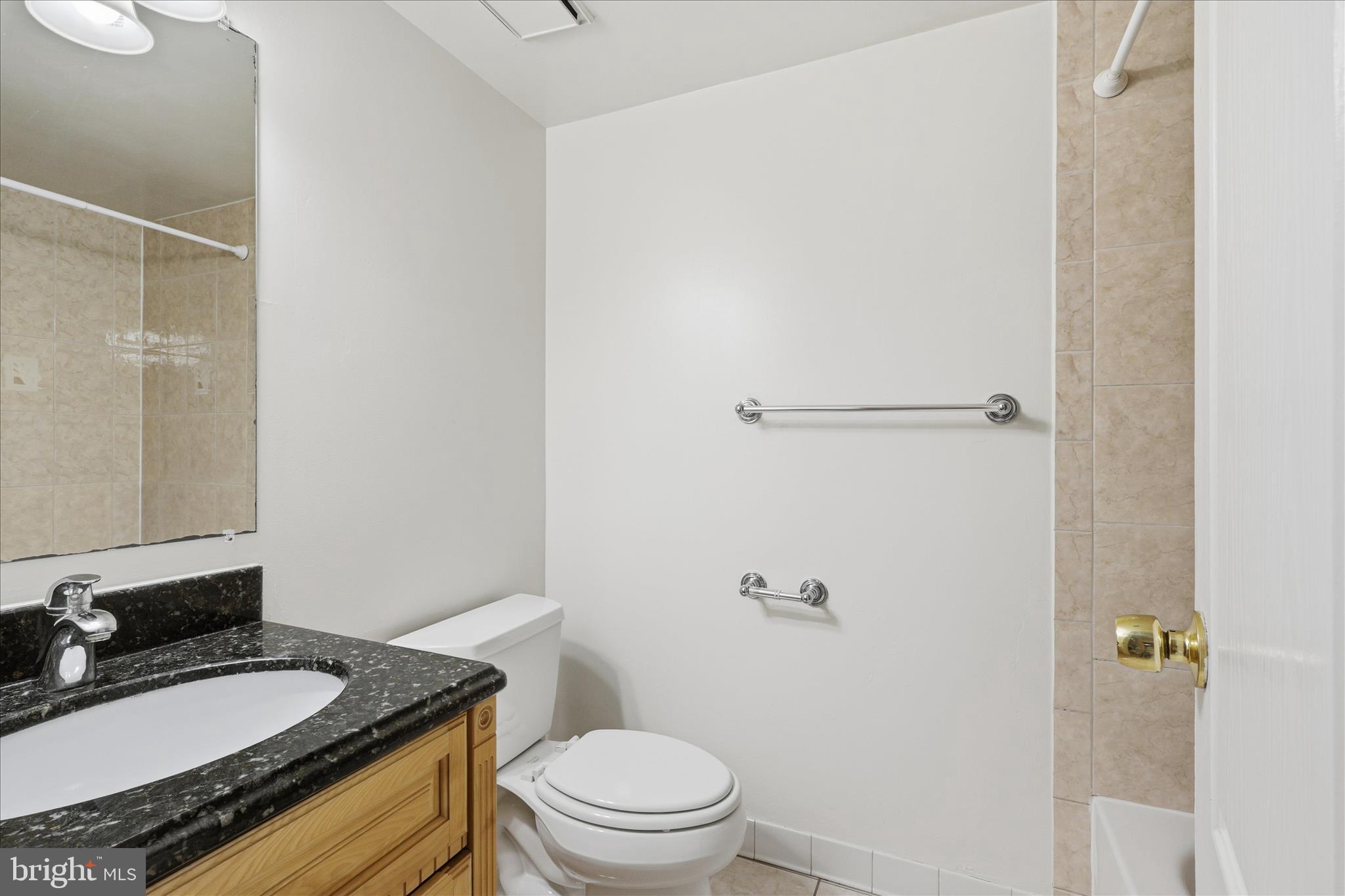2255 Castle Rock Square, Unit 21C Reston, VA 20191 - Photo 16 of 33 a bathroom with a granite countertop sink toilet a mirror and shower
