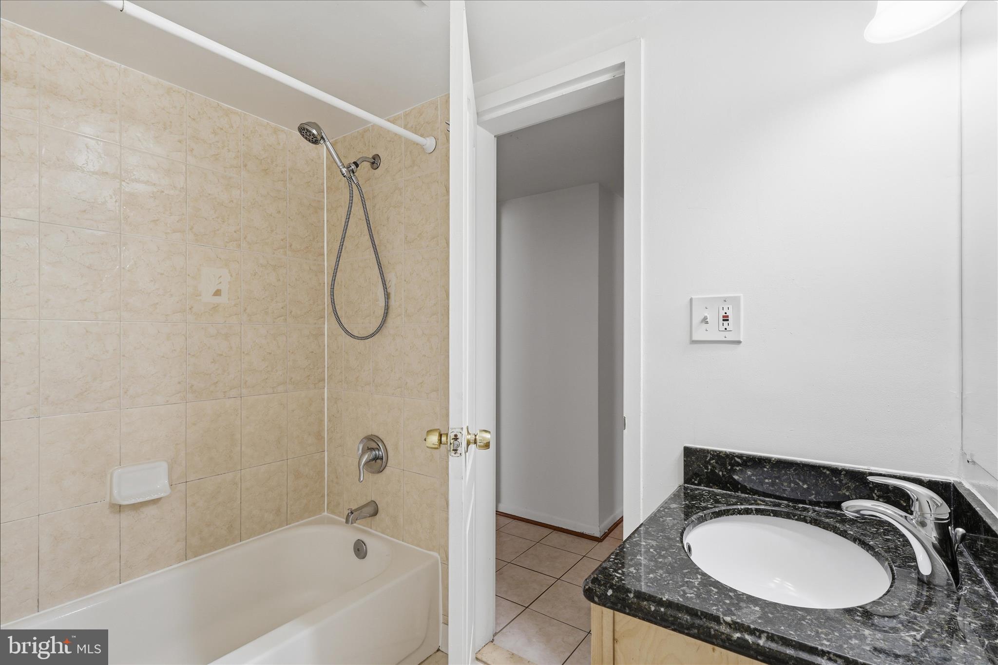 2255 Castle Rock Square, Unit 21C Reston, VA 20191 - Photo 17 of 33 a bathroom with a granite countertop sink a mirror and a bathtub