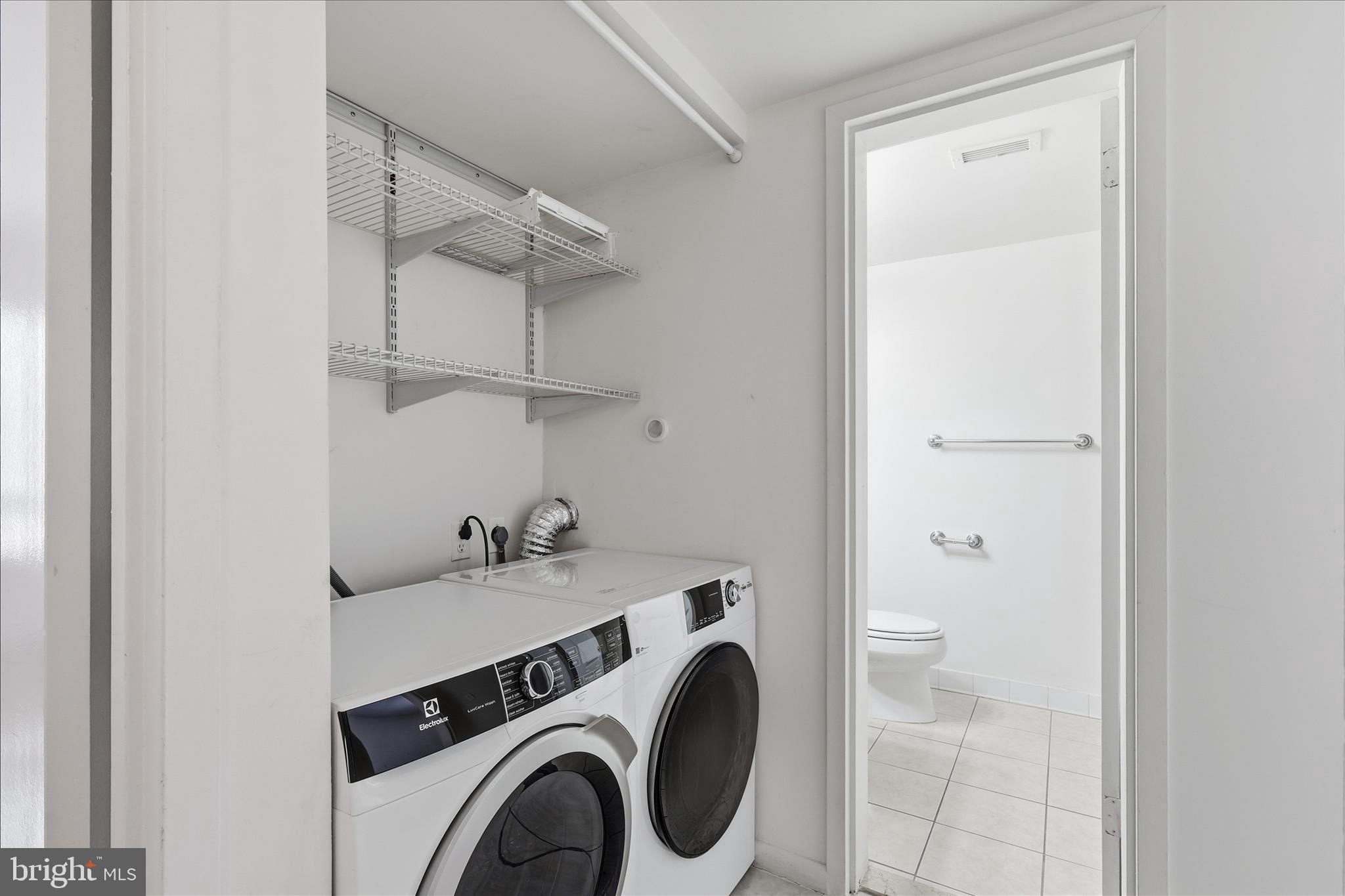 2255 Castle Rock Square, Unit 21C Reston, VA 20191 - Photo 18 of 33 a utility room with dryer and washer