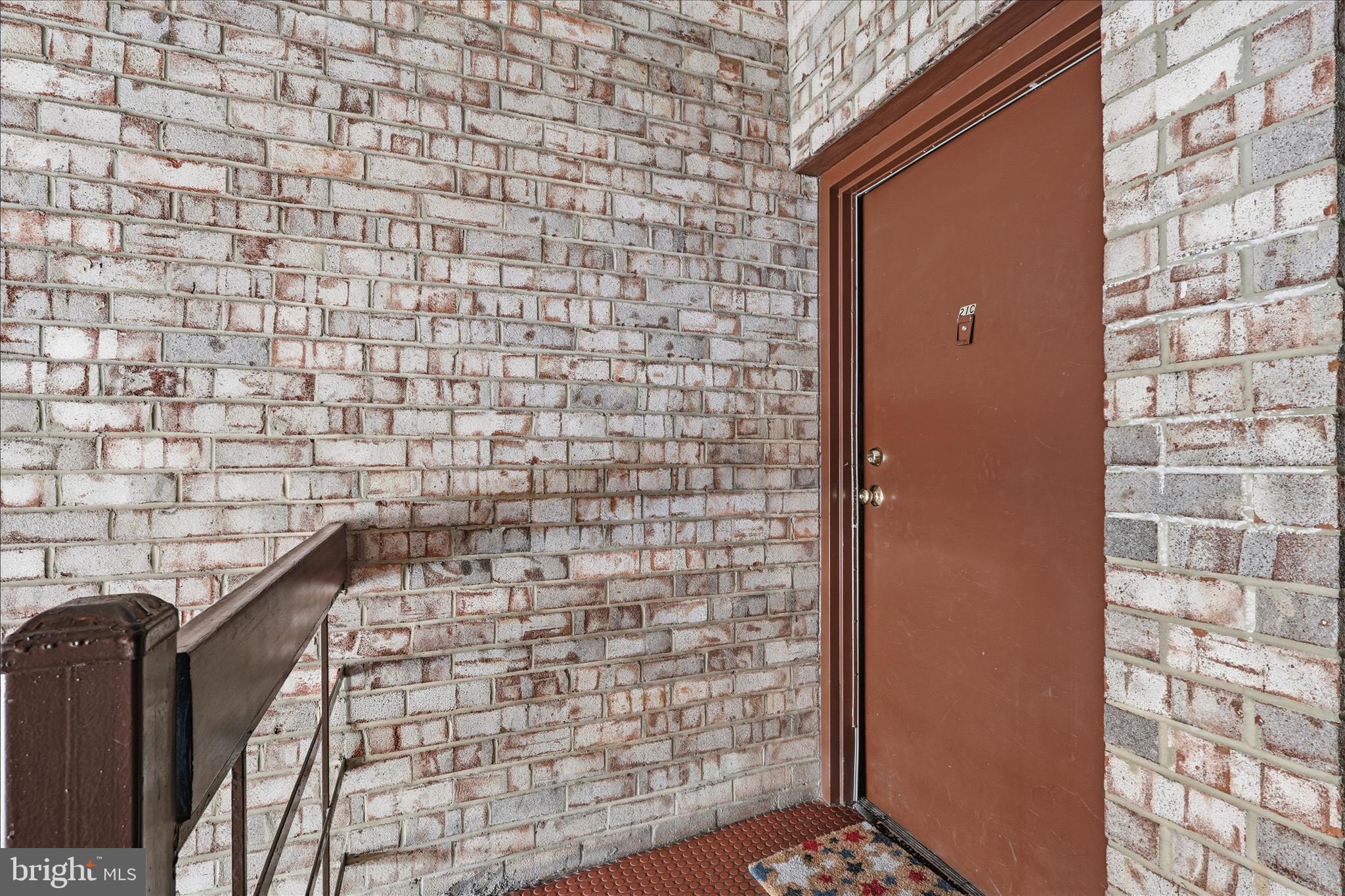 2255 Castle Rock Square, Unit 21C Reston, VA 20191 - Photo 2 of 33 a brick building with a glass door