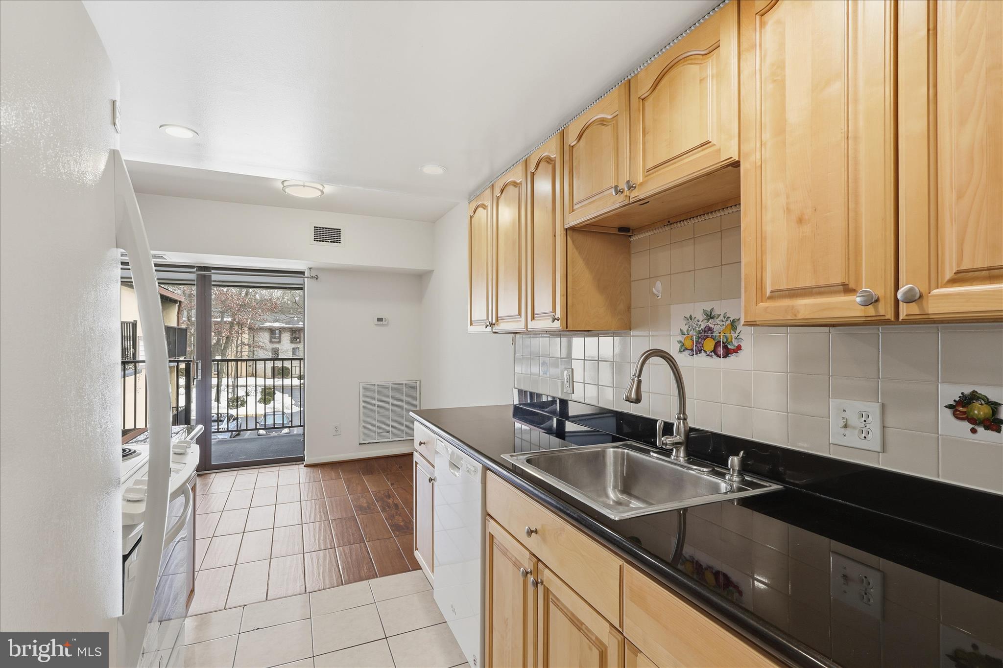 2255 Castle Rock Square, Unit 21C Reston, VA 20191 - Photo 4 of 33 a kitchen with a sink cabinets and window