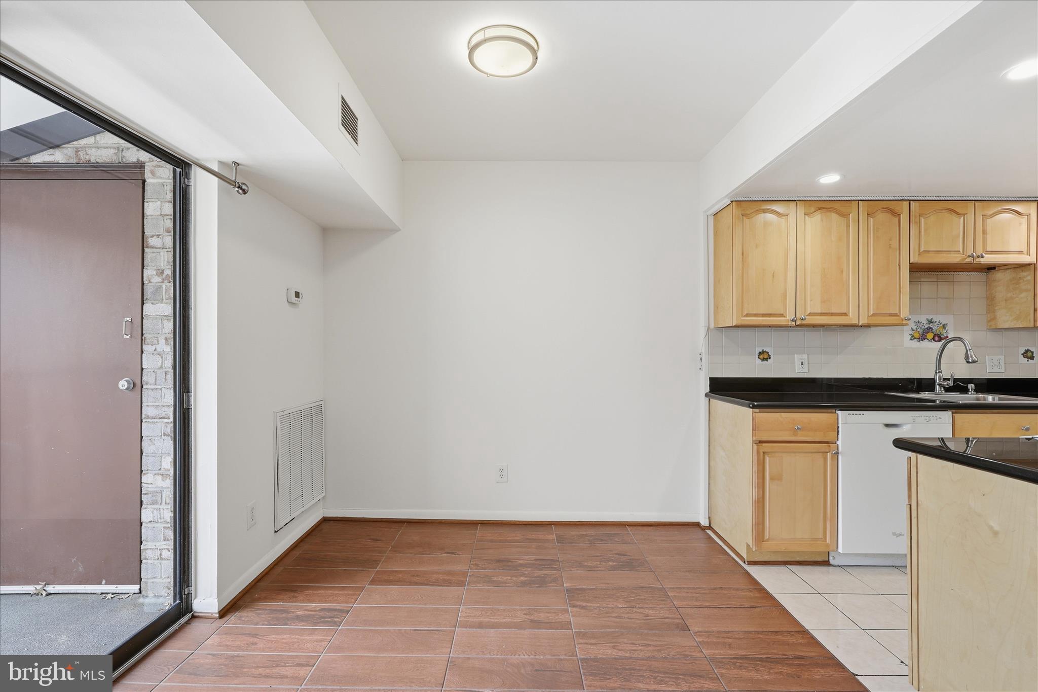2255 Castle Rock Square, Unit 21C Reston, VA 20191 - Photo 6 of 33 a view of kitchen with granite countertop cabinets sink and white appliances