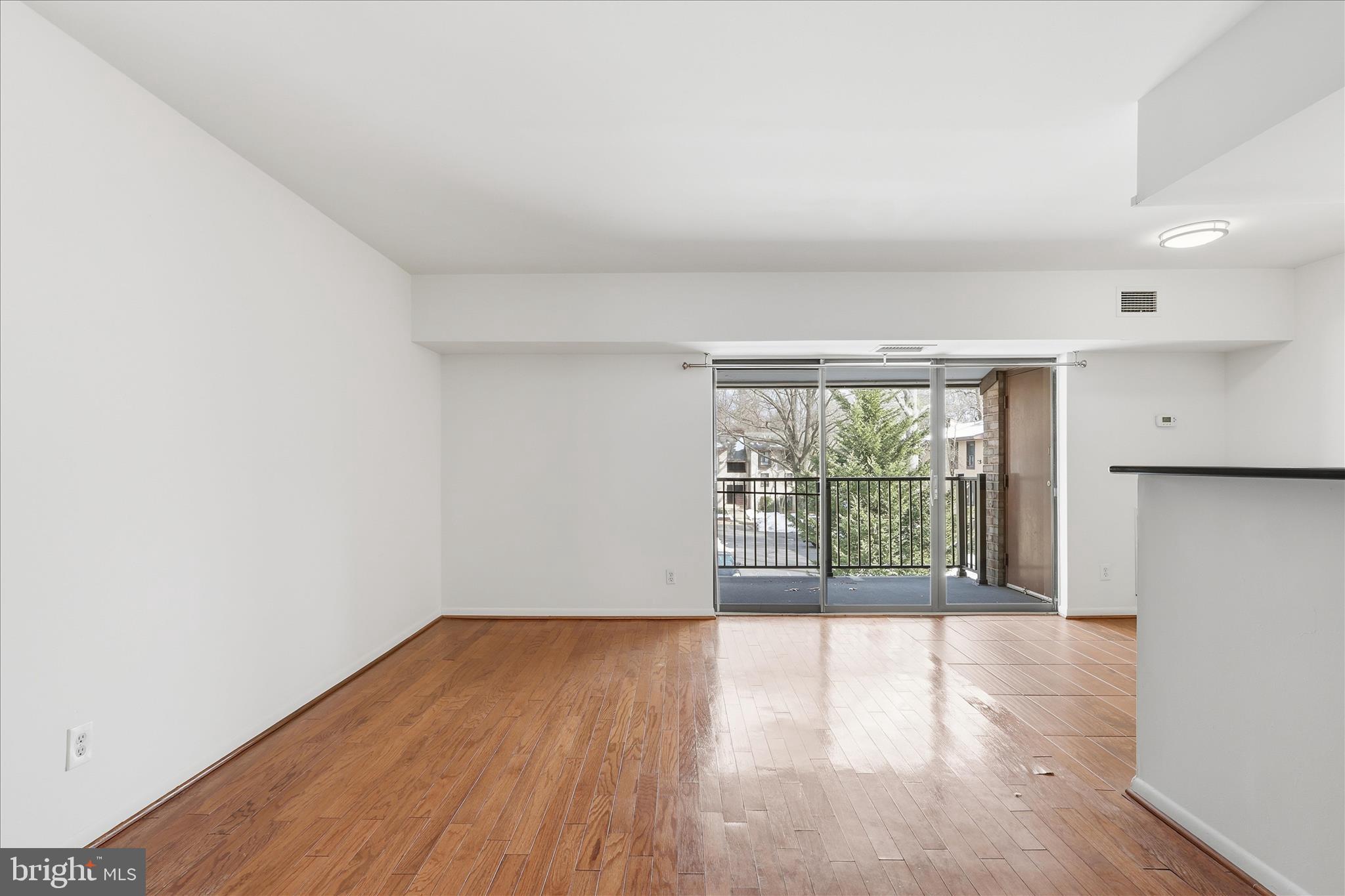 2255 Castle Rock Square, Unit 21C Reston, VA 20191 - Photo 7 of 33 wooden floor in an empty room with a window