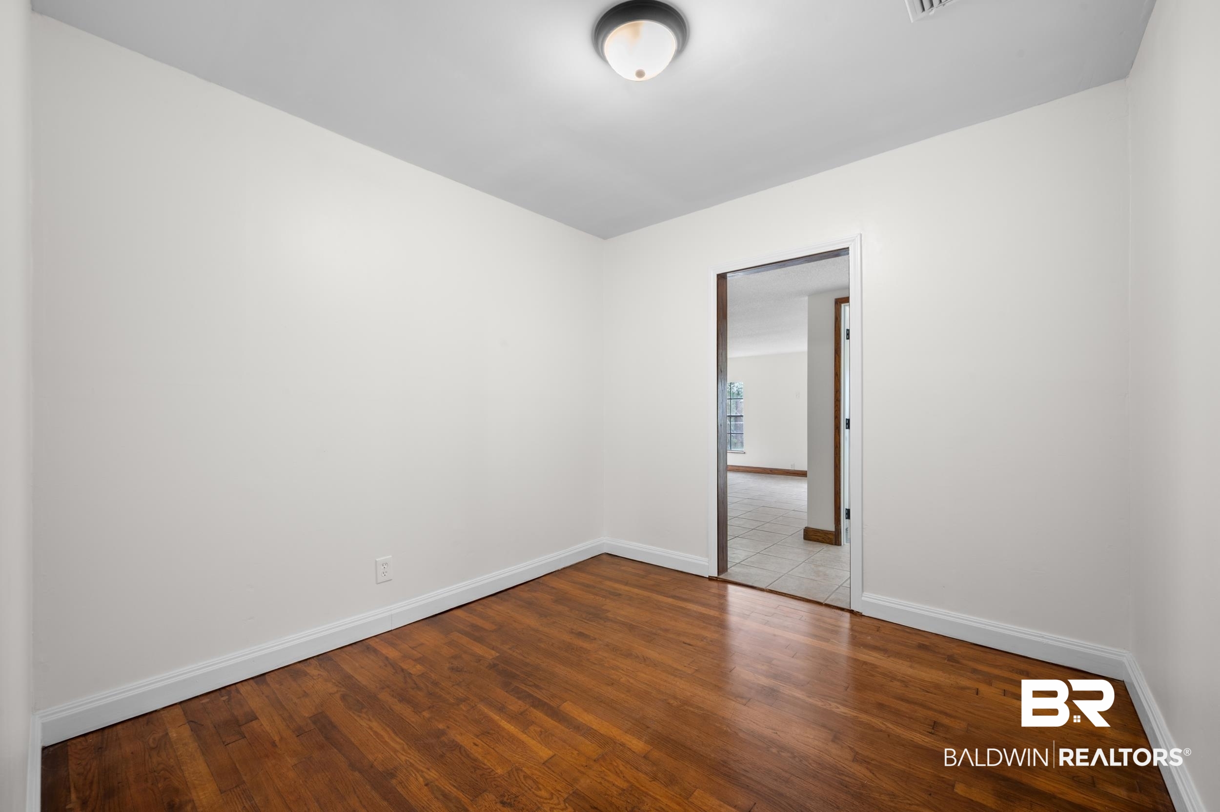 35780 Spring Road North Stapleton, AL 36578 - Photo 23 of 41 Empty room with wood-type flooring and baseboards
