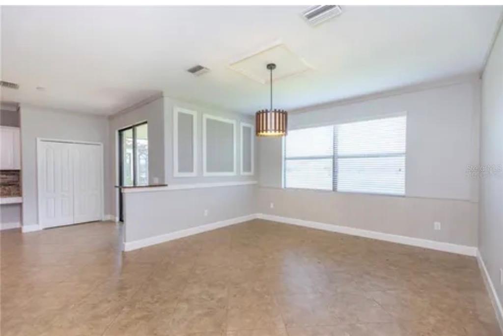 6914 Quiet Creek Drive Bradenton, FL 34212 - Photo 12 of 31 an empty room with chandelier fan and windows