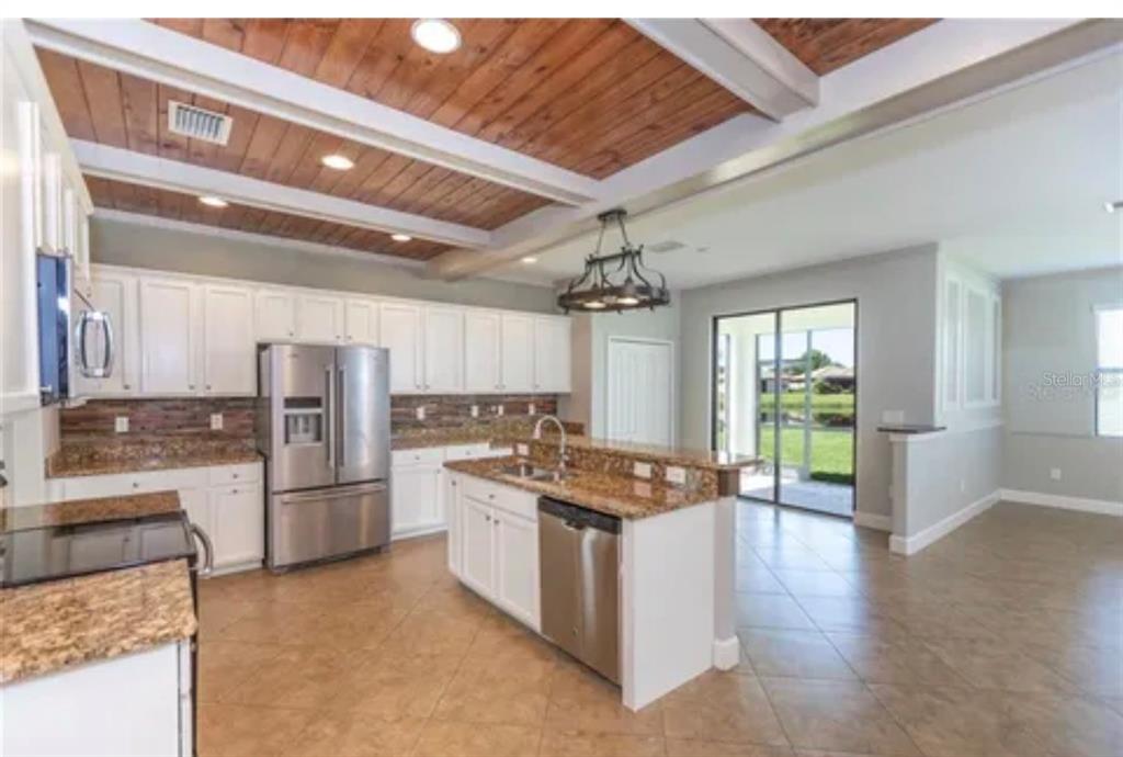 6914 Quiet Creek Drive Bradenton, FL 34212 - Photo 5 of 31 a kitchen with refrigerator and cabinets