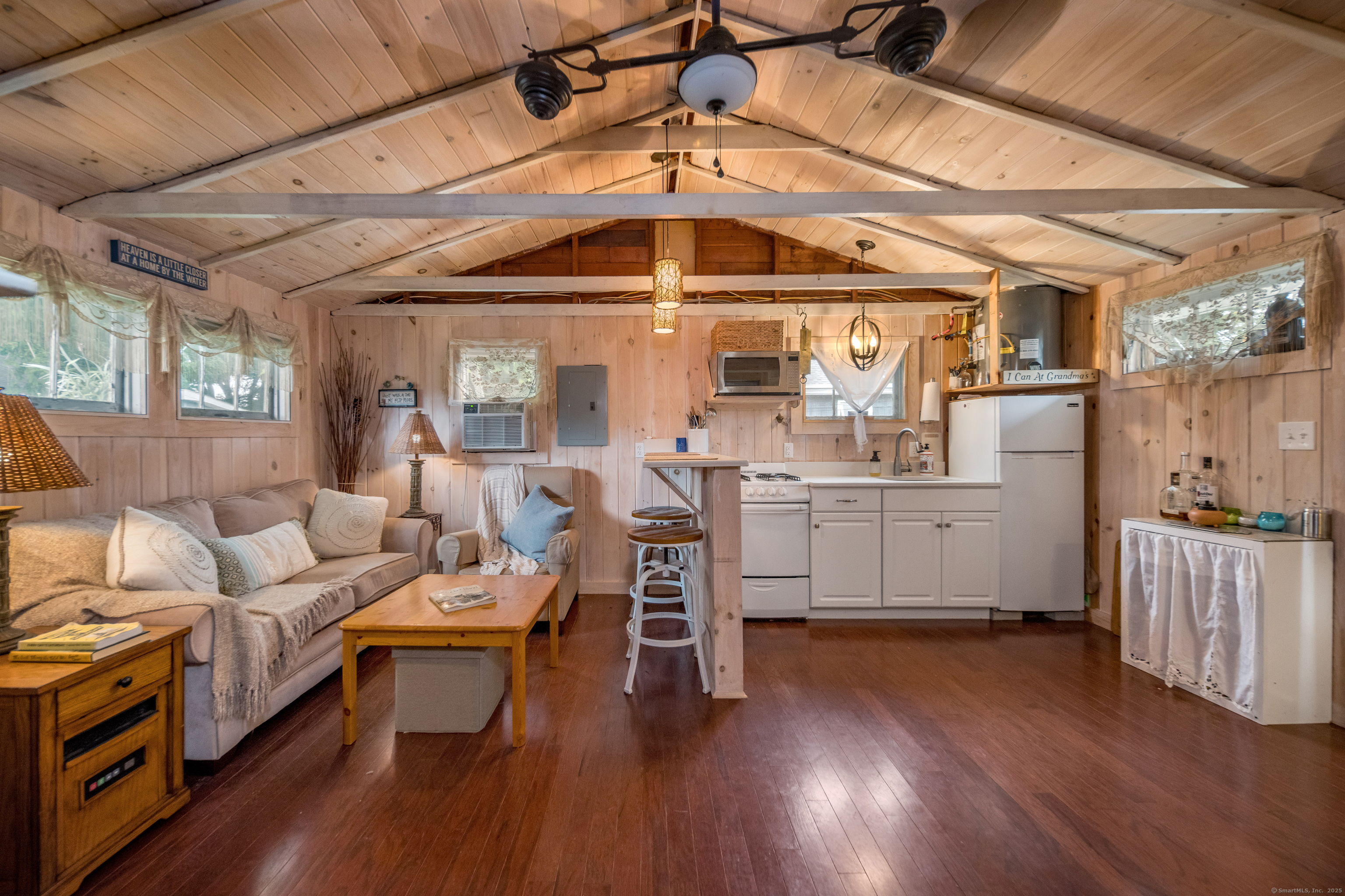 92 4th Avenue Madison, CT 06443 - Photo 1 of 19 a living room with furniture and a chandelier