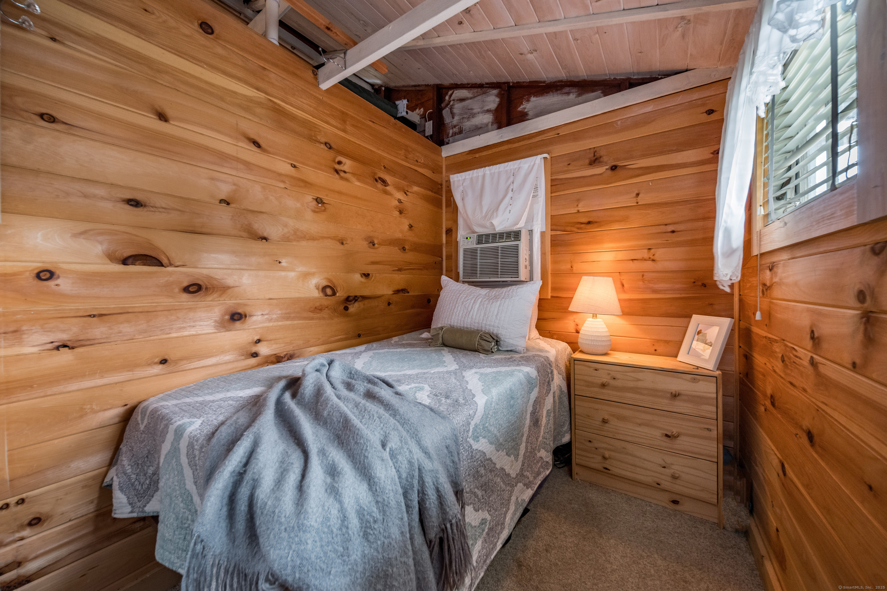 92 4th Avenue Madison, CT 06443 - Photo 11 of 19 a bedroom with a bed and a window