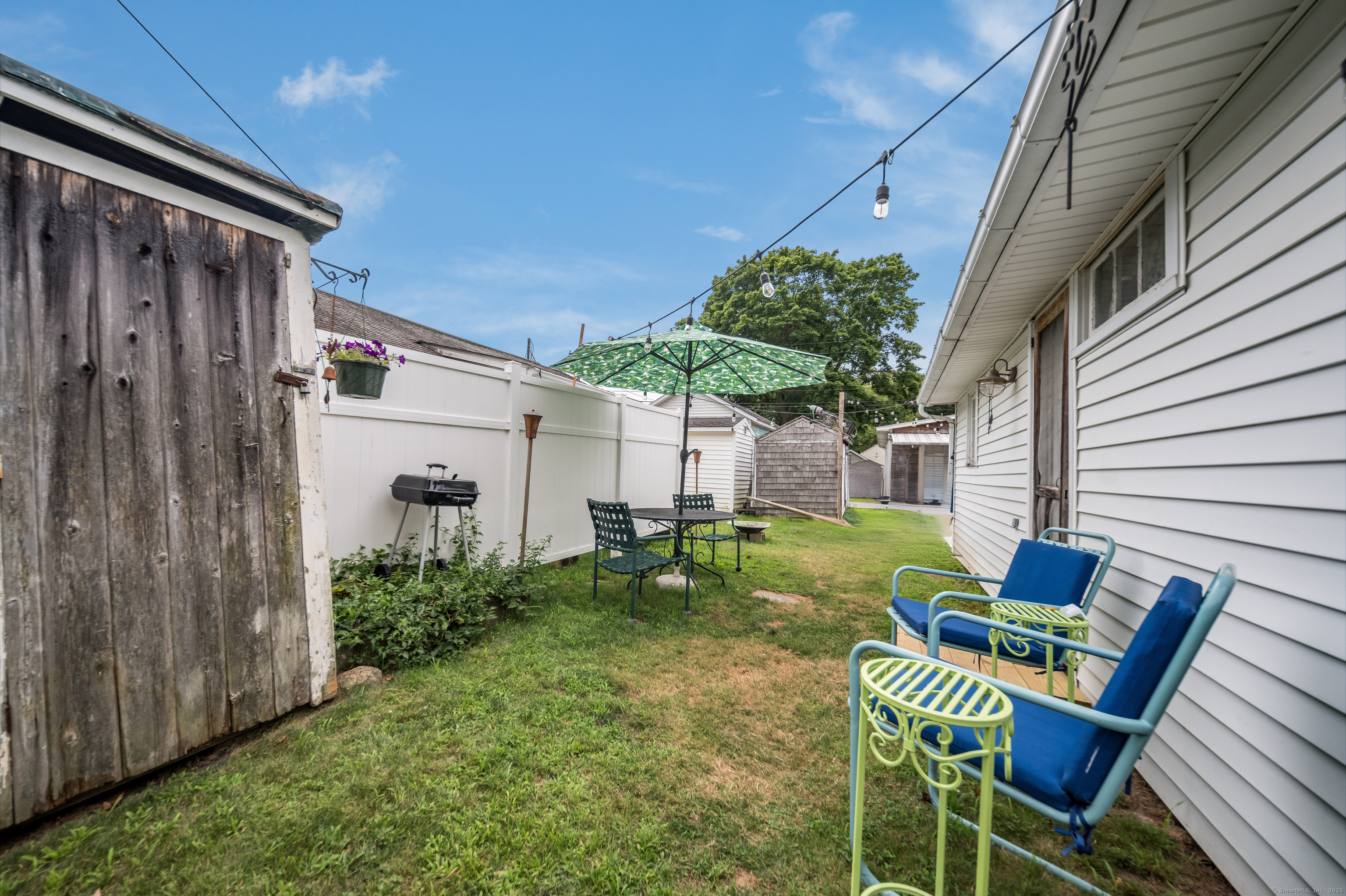 92 4th Avenue Madison, CT 06443 - Photo 17 of 19 a view of backyard of house with seating space