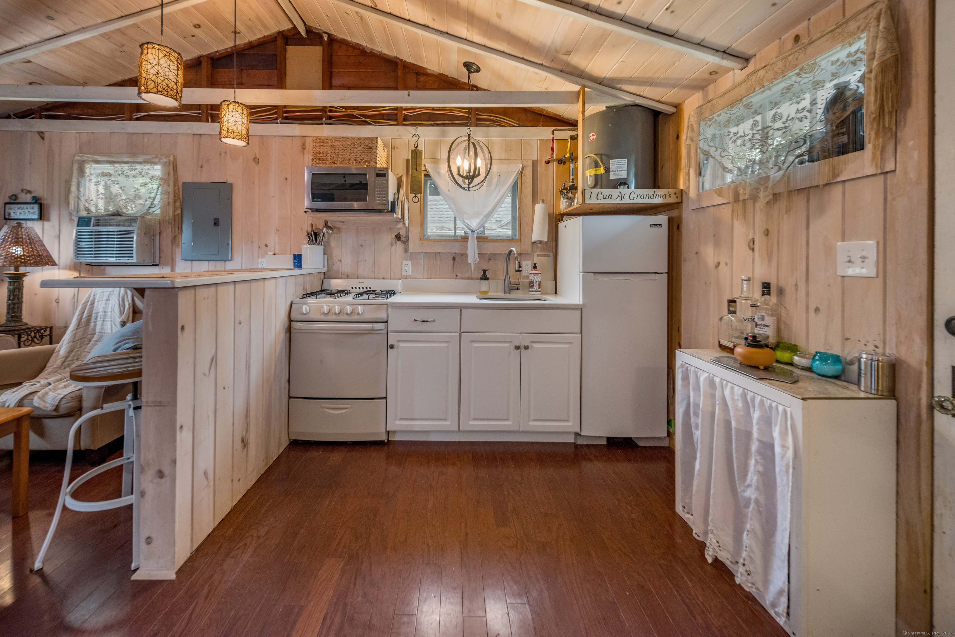 92 4th Avenue Madison, CT 06443 - Photo 5 of 19 a kitchen with stainless steel appliances wooden floor and more cabinets