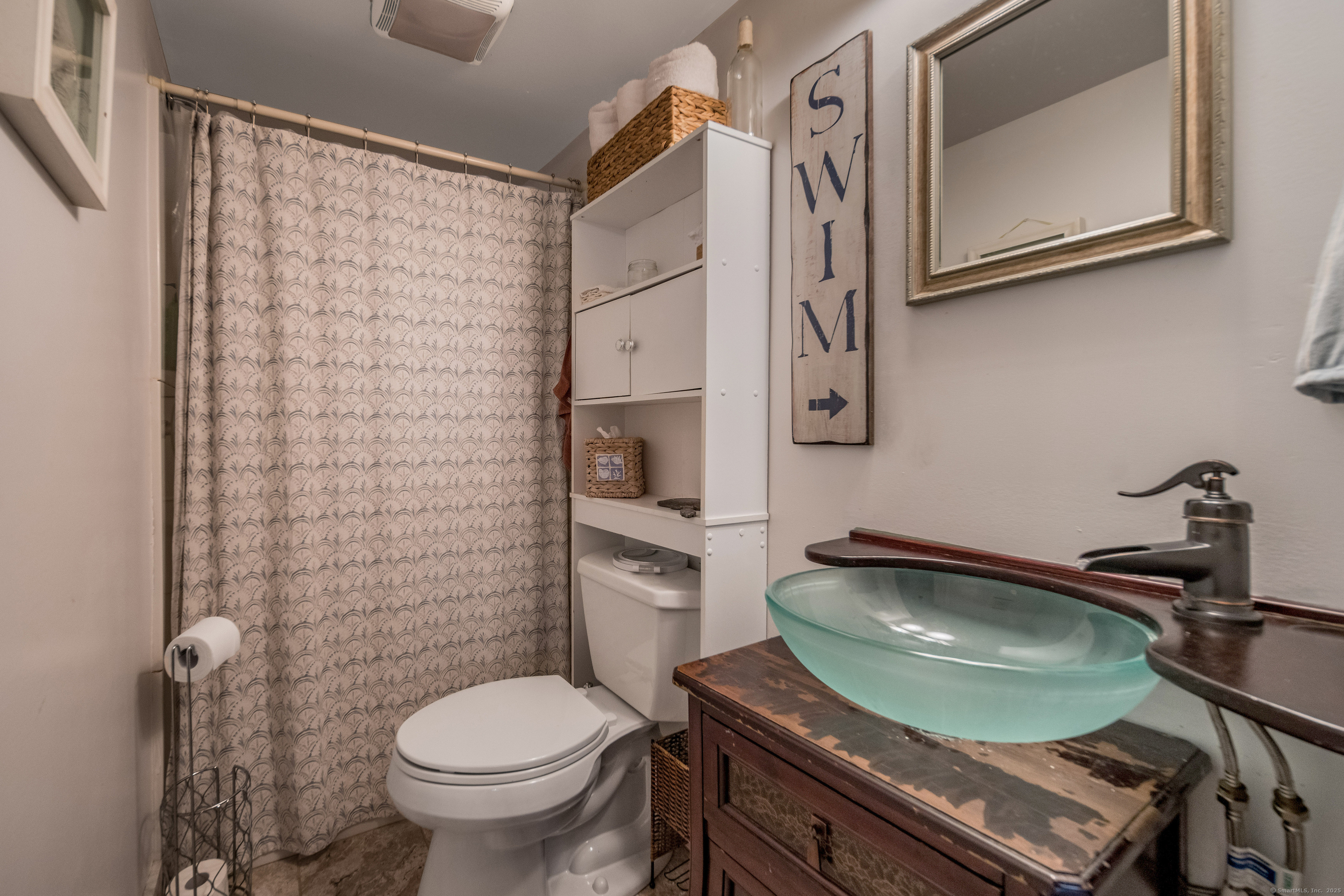 92 4th Avenue Madison, CT 06443 - Photo 9 of 19 a bathroom with a toilet a sink and mirror