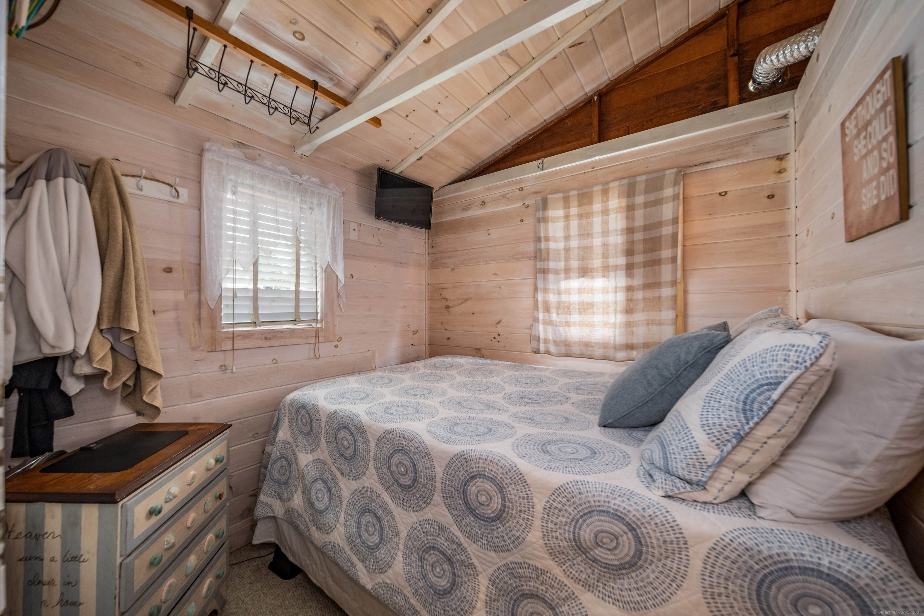 92 4th Avenue Madison, CT 06443 - Photo 10 of 19 a bedroom with a bed next to a window with the outer view