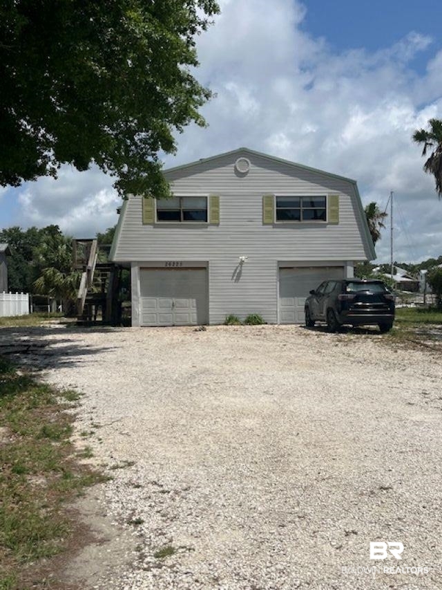 26225 Marina Road Orange Beach, AL 36561 - Photo 2 of 8 View of home's exterior with an attached garage and driveway