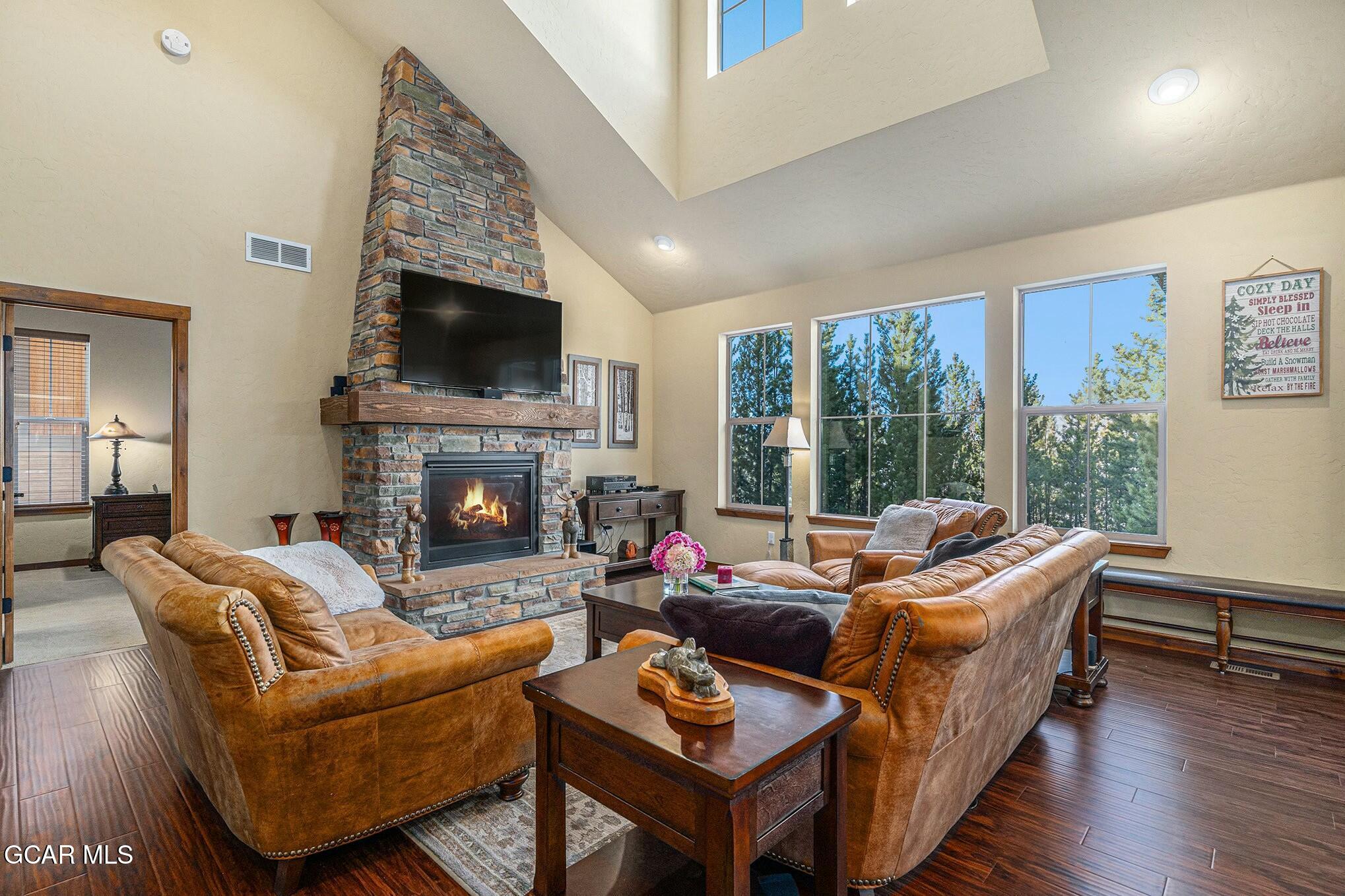 160 First Track Lane Granby, CO 80446 - Photo 2 of 27 a living room with furniture a flat screen tv and a fireplace