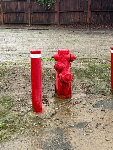 a view of a yard with red brick wall