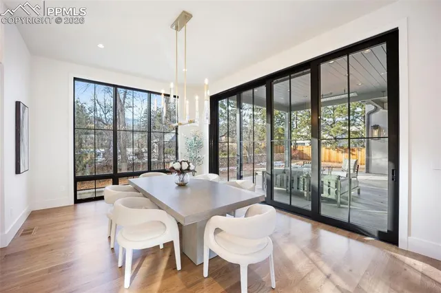a view of a dining room with furniture window and wooden floor