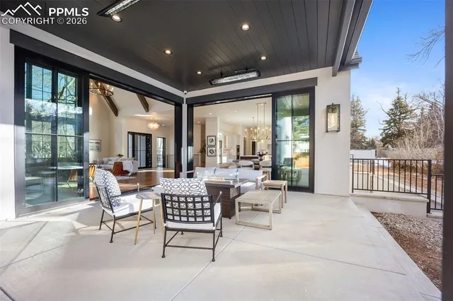 a building outdoor space with patio furniture and potted plants