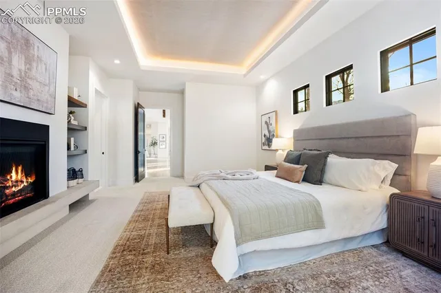 a bedroom with a bed a mirror and fireplace