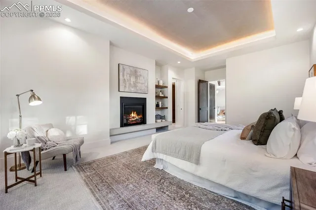 a bedroom with a bed and a fireplace
