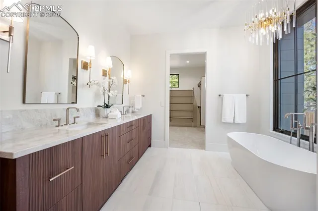 a large bathroom with a double vanity sink a mirror and a shower