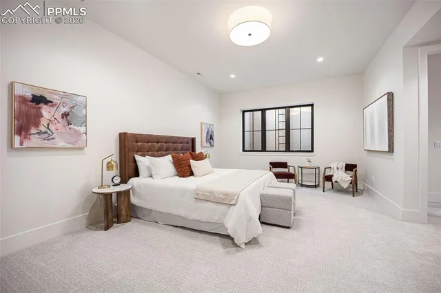 a bedroom with bed and a large window