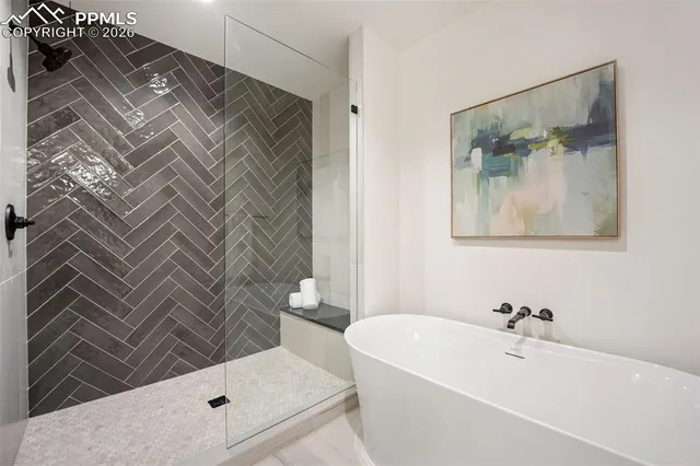 a bathroom with a bathtub and a shower