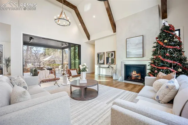 a living room with furniture fireplace and large window