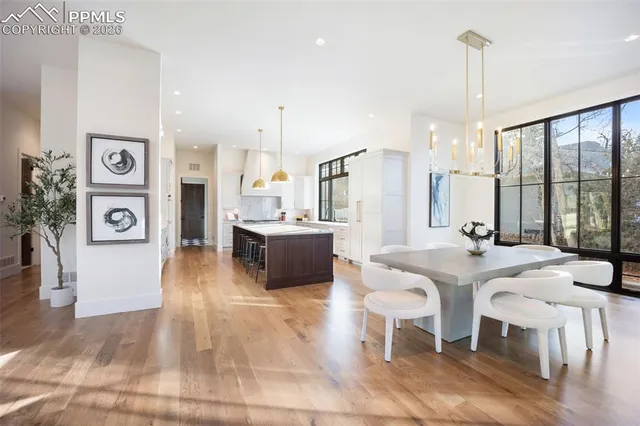 a large kitchen with a table and chairs