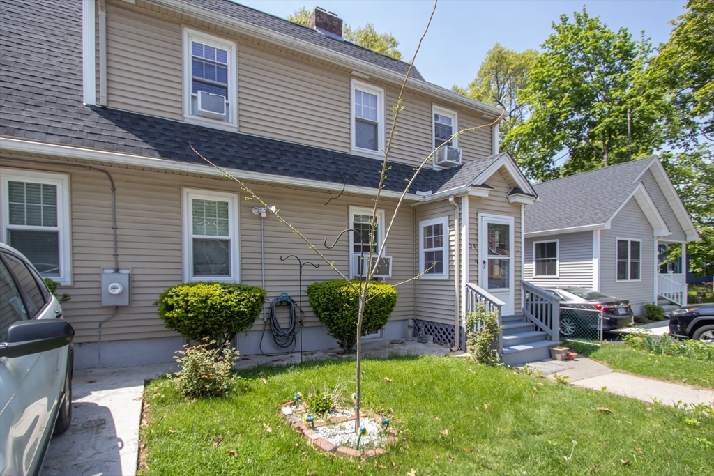 34 Preston Street Springfield, MA 01109 - Photo 4 of 34 a front view of a house with a yard and outdoor seating