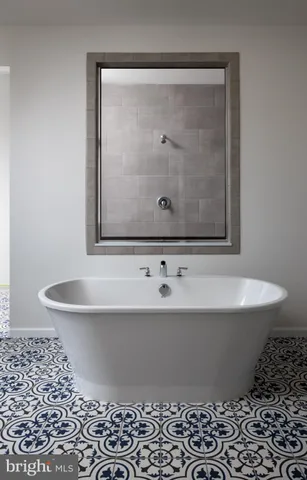 a white bath tub sitting in a bathroom
