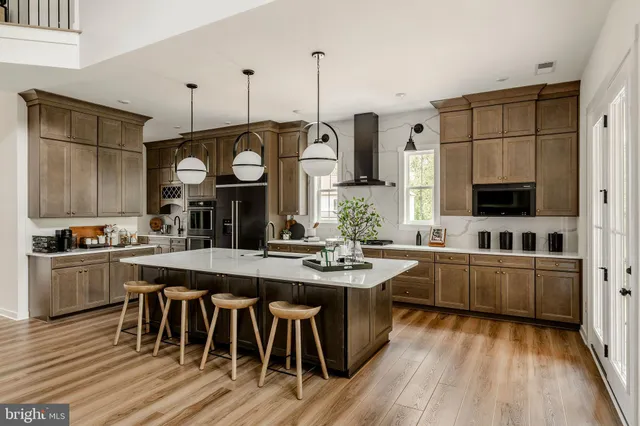 a kitchen with stainless steel appliances granite countertop a stove and cabinets