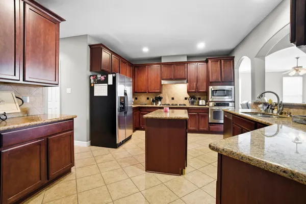 a kitchen with stainless steel appliances granite countertop a stove and a sink