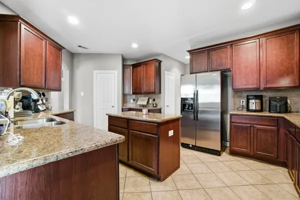 a dining room with furniture a chandelier and wooden floor