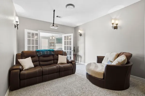 a spacious bedroom with a bed and a chandelier