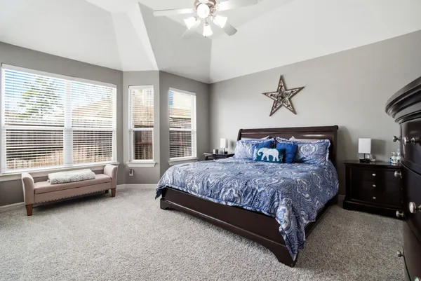 a bedroom with a bed and a chandelier
